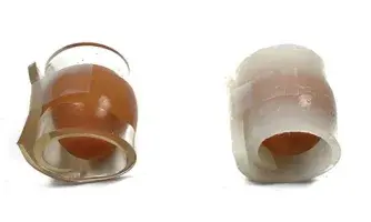 Two eggs wrapped in clear and opaque packaging