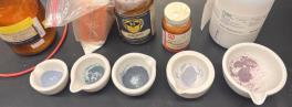 Mortars containing butterfly pea flowers ground together with various colorless solids